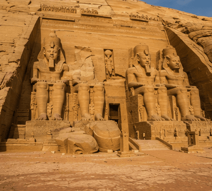 Colossal seated figures cut into a cliff face