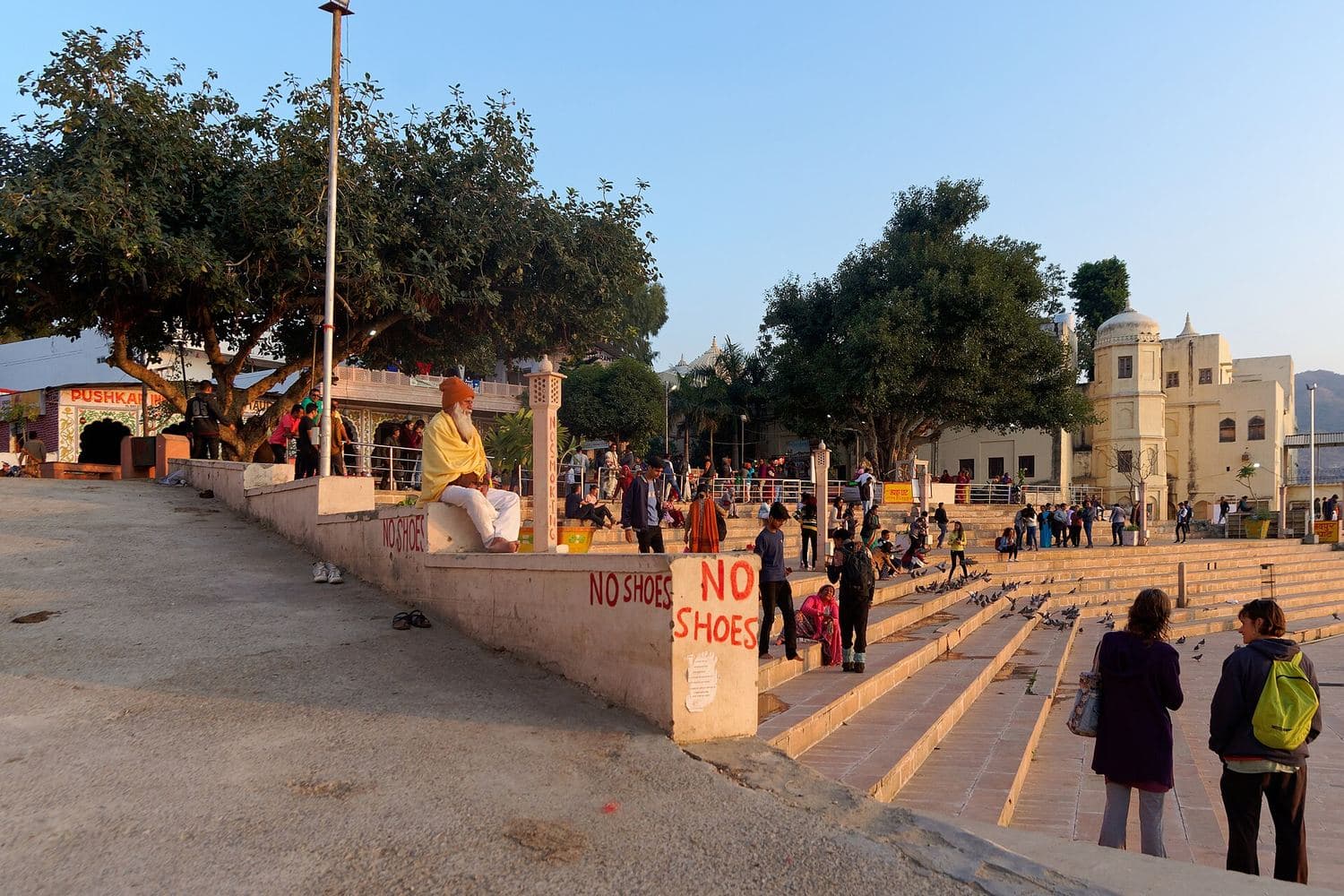 Pilgrims on the stone ghats beside Pushkar Lake